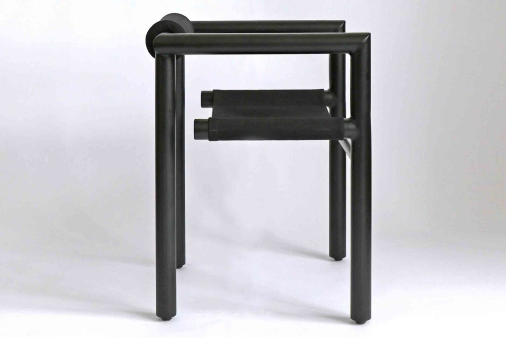 Studio PALAIUS: MAE Chair. The image shows a side profile of the black chair on a white background.