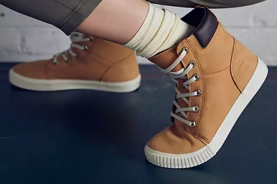 Timberland's brown suede boots worn by a woman with white socks