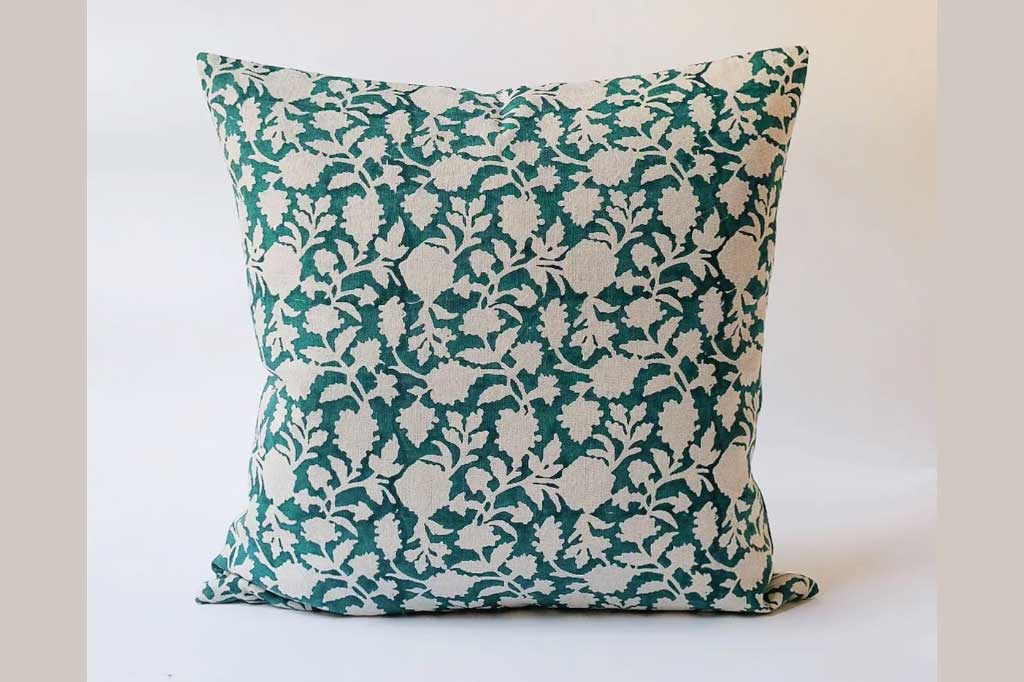 A green decorative pillow in floral pattern