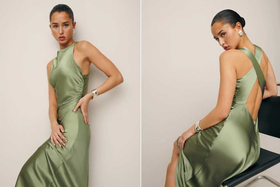 A woman wears a green eco friendly silk dress from reformation